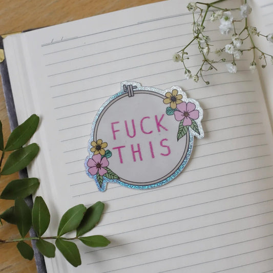 Puhelinan ristipistotyö tarra tekstillä "Fuck this"